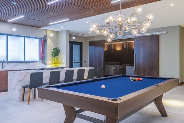 Clubhouse kitchen and game room featuring modern design elements at Elan Yorktown Apartments