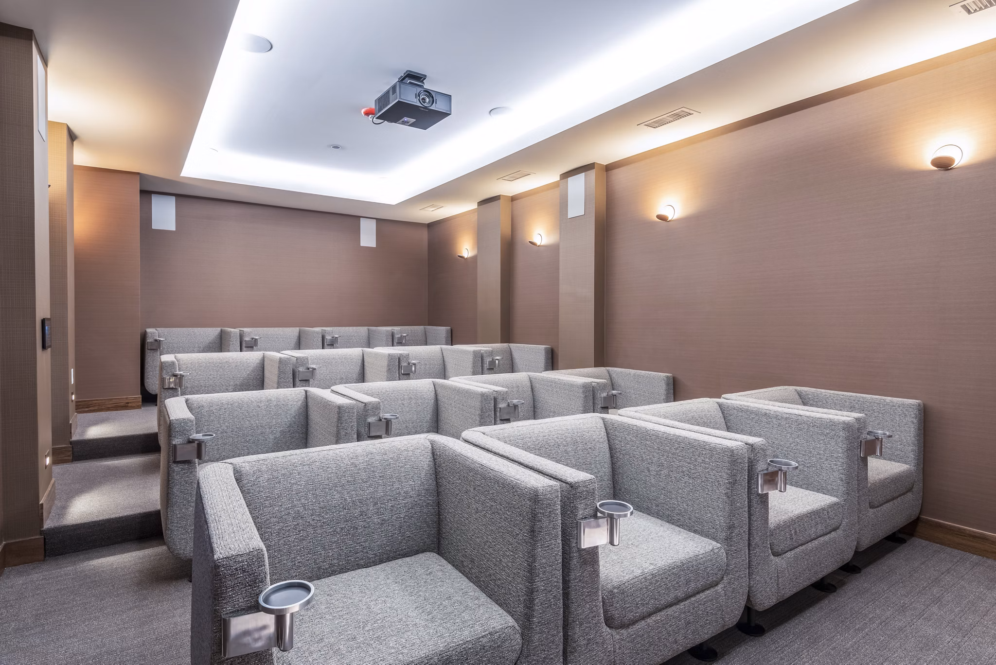 Clubhouse theater with plush seating and large screen at Elan Yorktown Apartments luxury community
