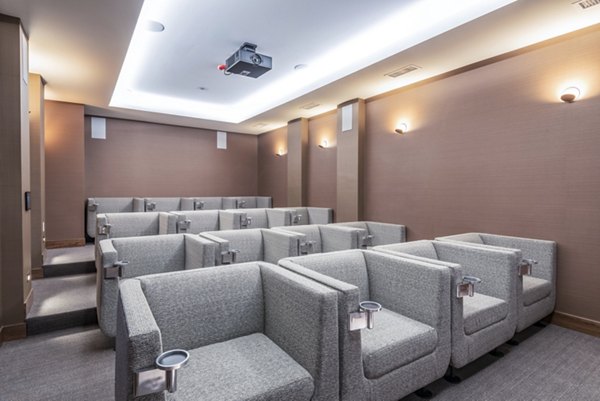 Clubhouse theater with plush seating and large screen at Elan Yorktown Apartments luxury community