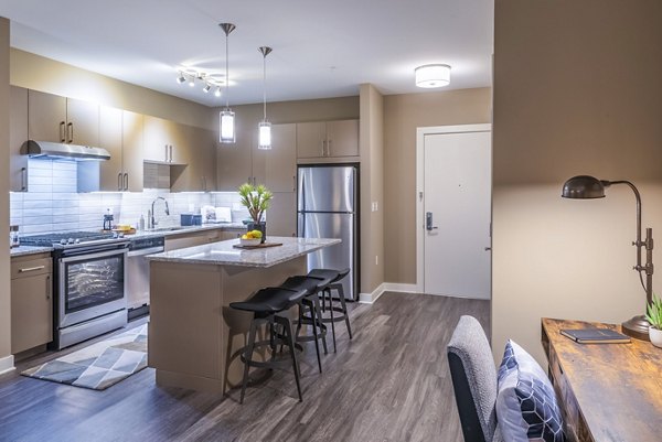 Modern kitchen with island and home office nook in Elan Yorktown Apartments