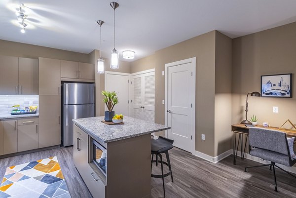 Spacious modern kitchen with granite countertops and stainless steel appliances in Elan Yorktown Apartments