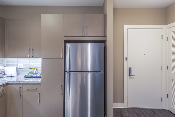 Modern kitchen with stainless steel appliances at Elan Yorktown Apartments, luxury living in a Greystar community