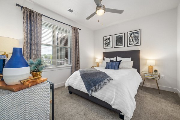 Spacious bedroom with modern decor at Republic Flats Apartments in Austin