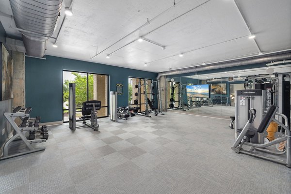 Fully-equipped fitness center at Republic Flats Apartments with modern cardio machines and free weights for residents' wellness and exercise