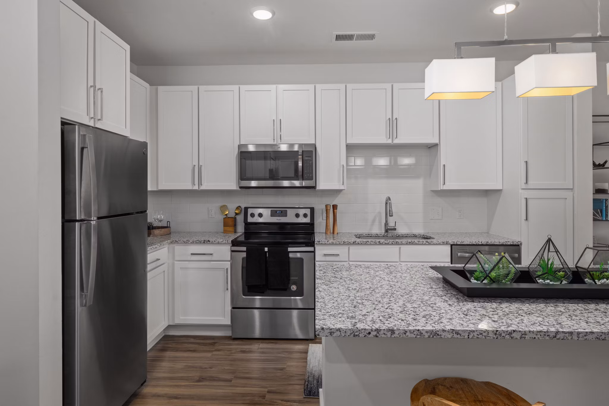 Modern kitchen featuring stainless steel appliances and quartz countertops in Republic Flats Apartments