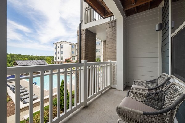 Private balcony with modern seating at Republic Flats Apartments, offering luxurious outdoor relaxation spaces in a vibrant urban setting