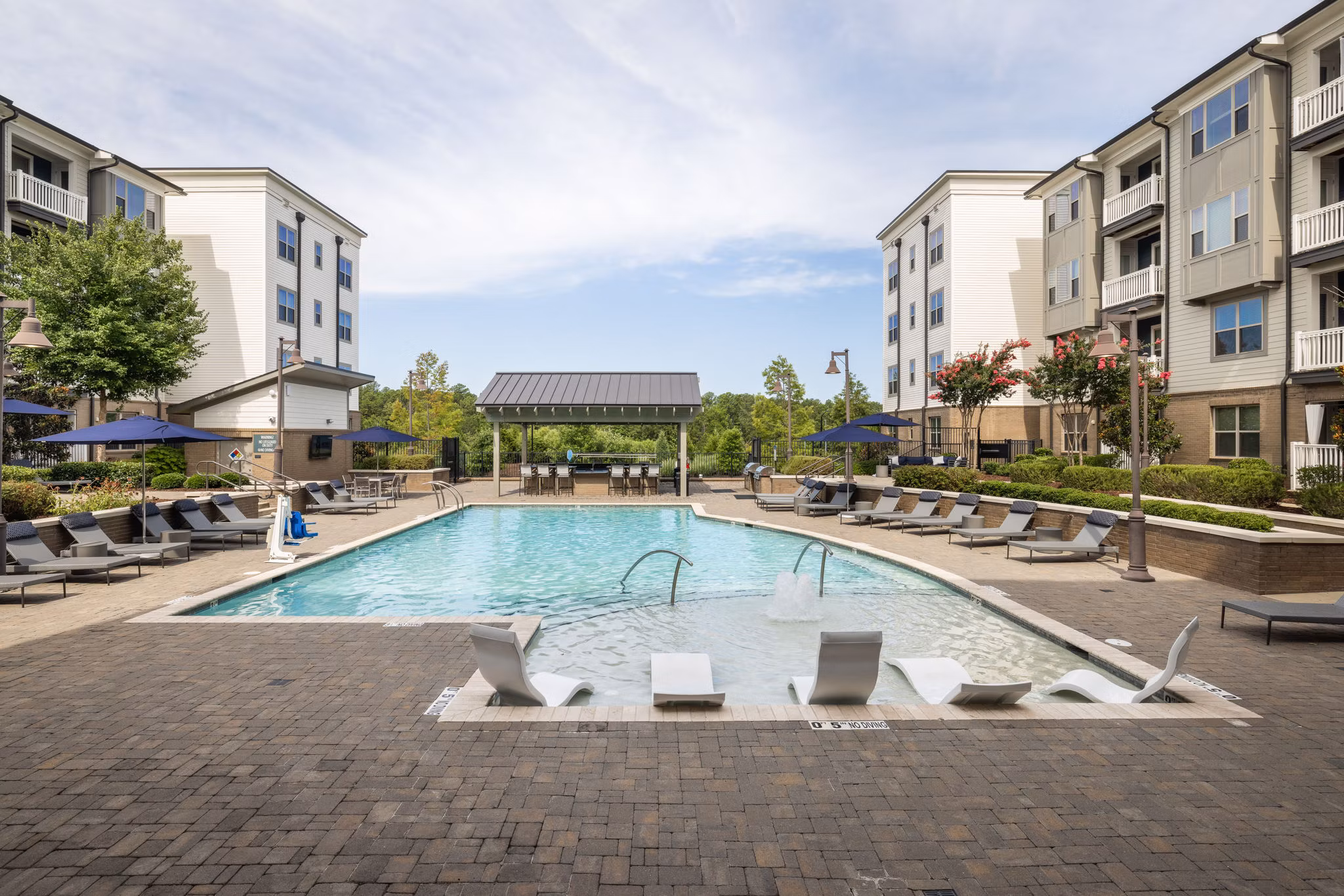 Outdoor pool with lounge chairs at Republic Flats Apartments