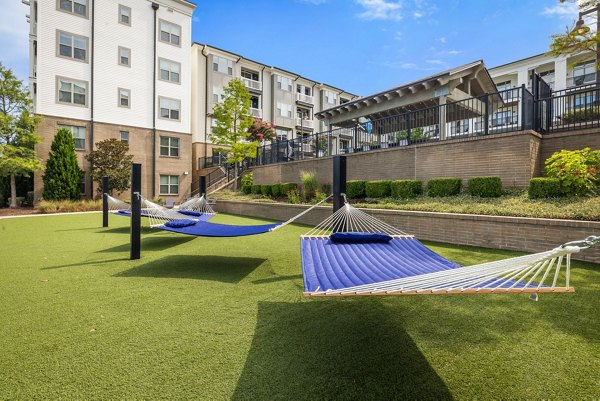 Outdoor recreational area with lush gardens at Republic Flats Apartments