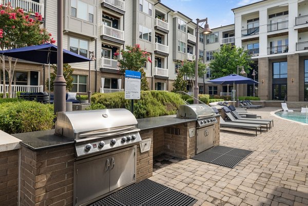 Outdoor grill area at Republic Flats Apartments, featuring modern BBQ facilities and seating areas, perfect for social gatherings and relaxation