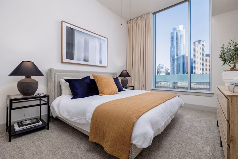 Contemporary bedroom featuring elegant decor and large windows at Northshore Apartments