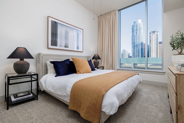 Contemporary bedroom featuring elegant decor and large windows at Northshore Apartments