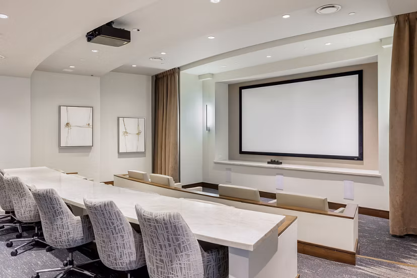 Modern theater in the clubhouse of Northshore Apartments with plush seating and large screen for residents' entertainment