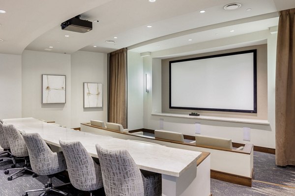 Modern theater in the clubhouse of Northshore Apartments with plush seating and large screen for residents' entertainment