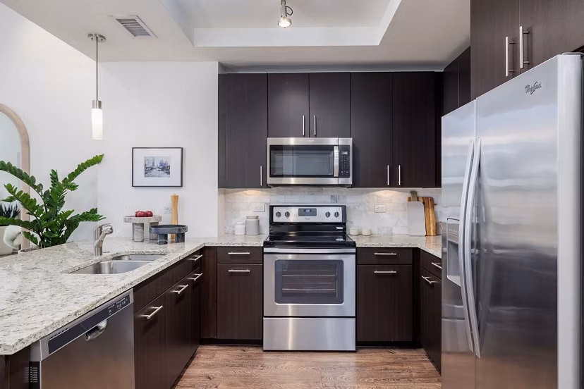 Modern kitchen with sleek countertops and stainless steel appliances in Northshore Apartments, luxury living in a coastal setting