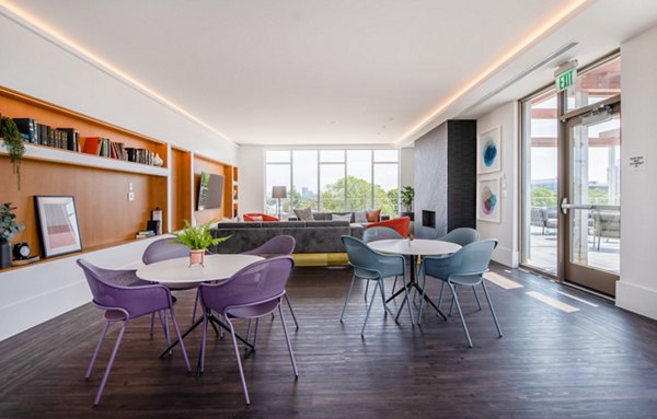 Modern clubhouse featuring stylish seating and entertainment options at Radius Apartments in a vibrant community setting