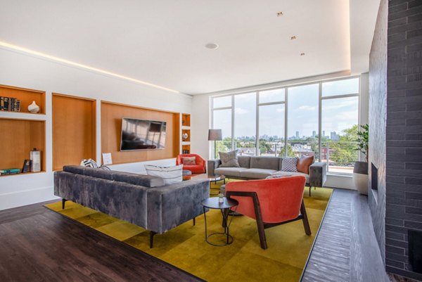 Modern clubhouse with cozy seating and game areas at Radius Apartments, an upscale community