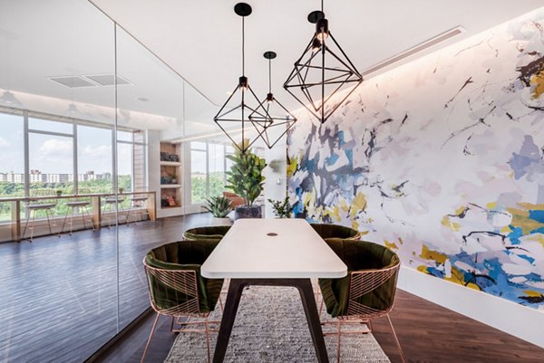 Modern clubhouse with lounge seating and pool table at Radius Apartments