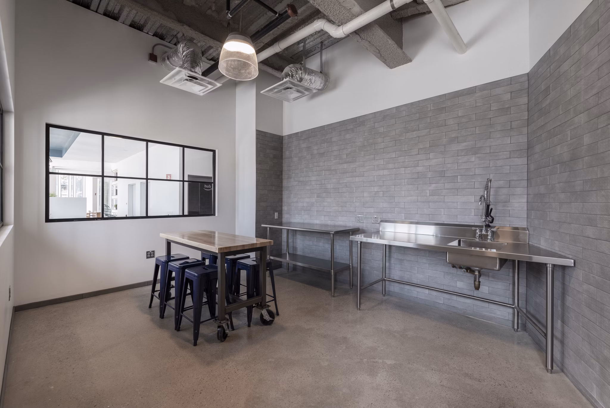 Modern clubhouse with expansive seating and billiard tables at Radius Apartments, a luxury community offering premium amenities and social spaces