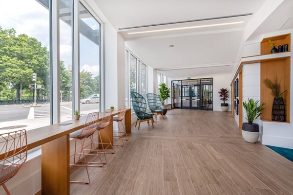 Clubhouse featuring modern design and ample seating at Radius Apartments, ideal for social gatherings and relaxation spots