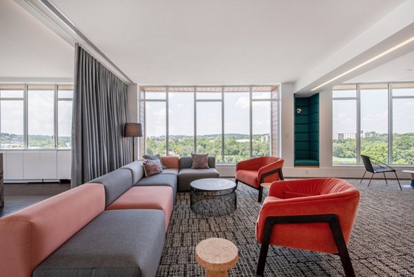 Modern clubhouse featuring stylish seating and a large screen TV at Radius Apartments, perfect for social gatherings and relaxation