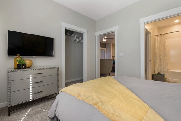 Bedroom with modern decor and large windows at Proximity Northlake Apartments