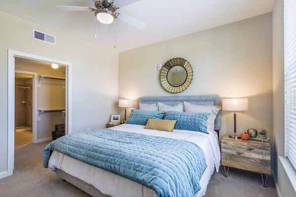 Cozy bedroom with large windows at Overture Frisco Apartments