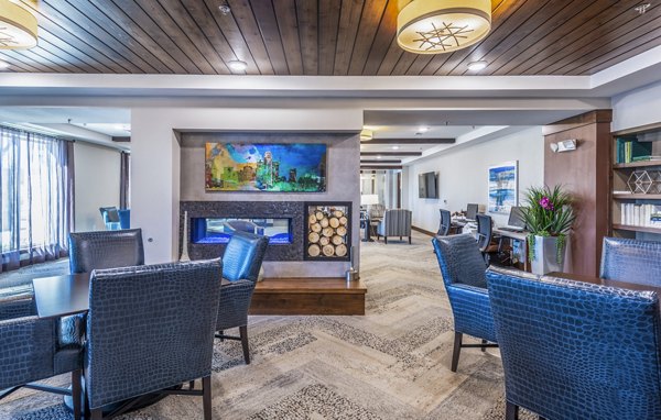 Clubhouse at Overture Frisco Apartments: Stylish lounge with modern decor and ample seating for social gatherings