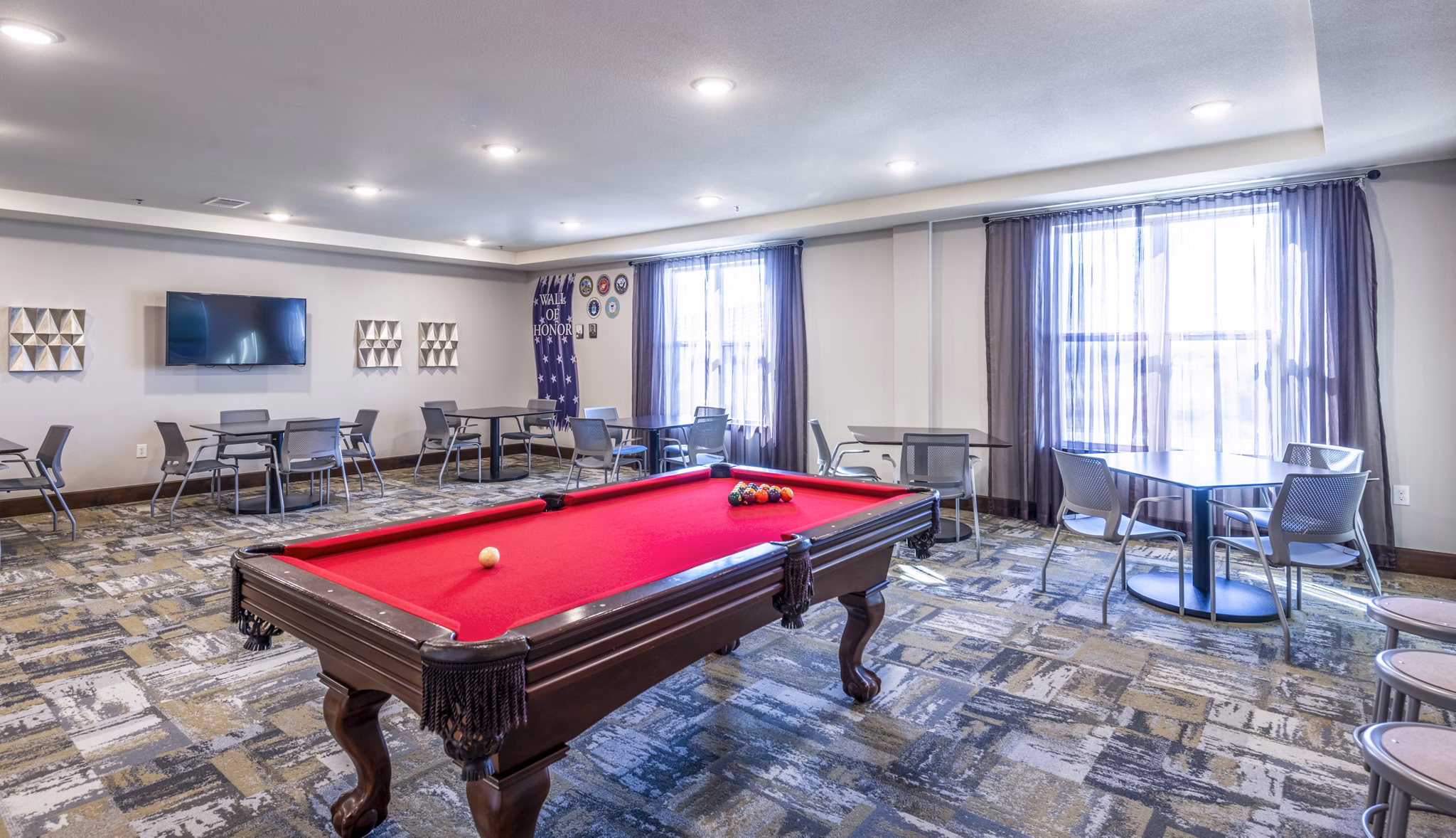 Clubhouse game room featuring pool table and lounge seating at Overture Frisco Apartments, offering luxury living and vibrant social spaces