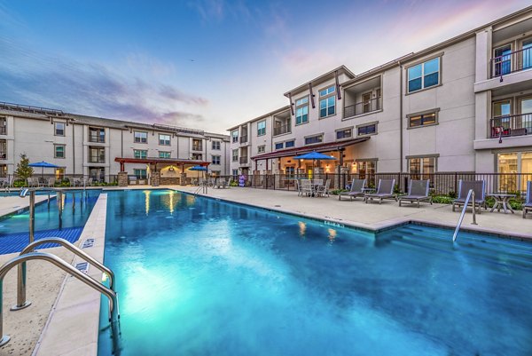 Stylish outdoor pool at Overture Frisco Apartments offering resort-style relaxation and leisure