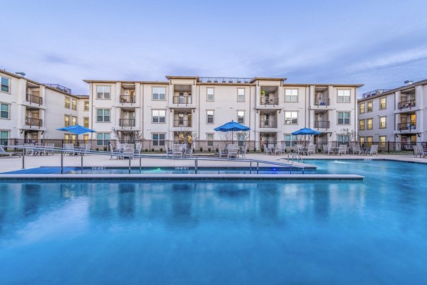 Olympic-sized outdoor pool at Overture Frisco Apartments offering luxury leisure space and modern surroundings for an exceptional living experience