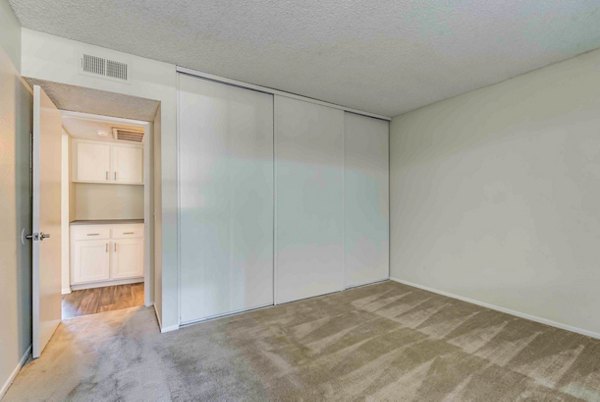 Cozy bedroom featuring elegant decor and natural light at Solana at Grand Apartments