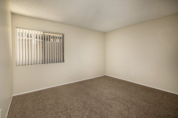 Solana at Grand: Cozy bedroom with modern decor and ample natural light