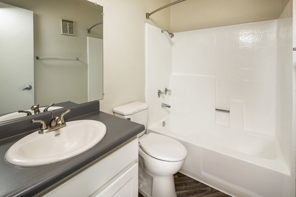 Modern bathroom with marble countertops and large mirrors at Solana at Grand luxury apartments