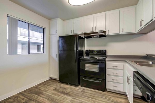 Modern kitchen with stainless steel appliances and granite countertops at Solana at Grand Apartments