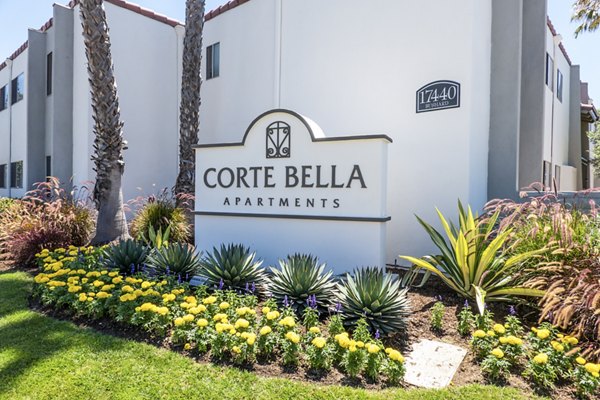 Corte Bella Apartments entrance signage displaying the community name in a lush garden setting