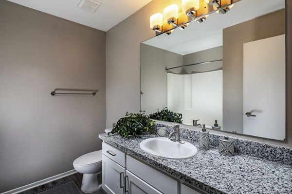 Elegant bathroom with marble countertops and modern fixtures at Corte Bella Apartments