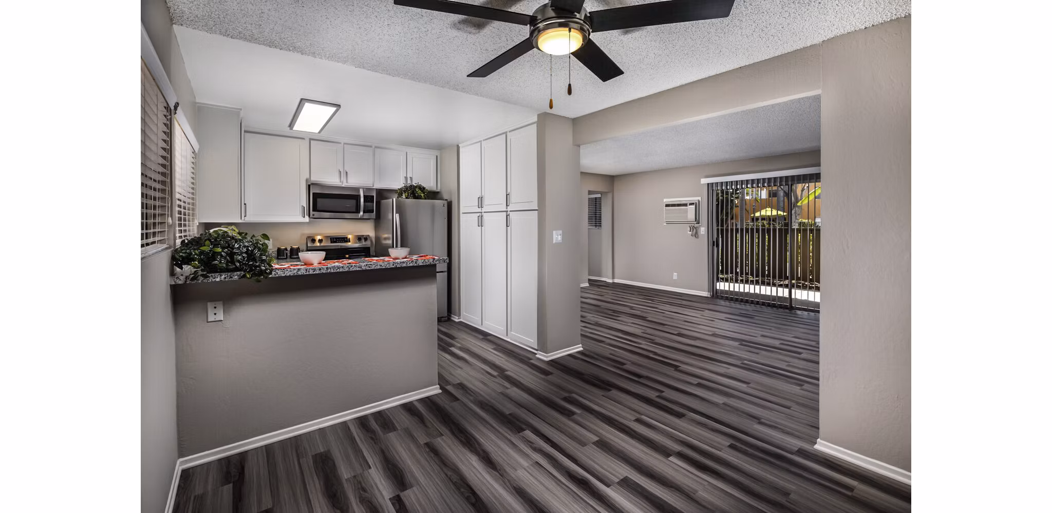 Dining room with elegant decor and large windows at Corte Bella Apartments