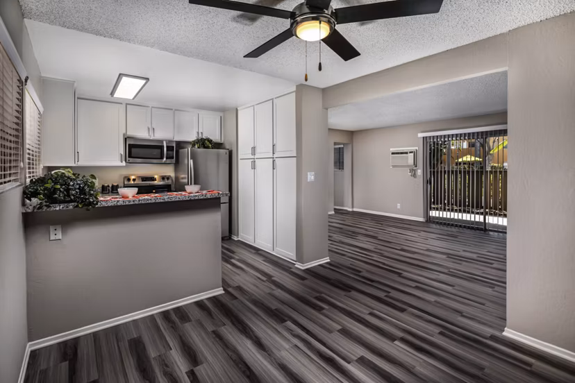 Dining room with elegant decor and large windows at Corte Bella Apartments