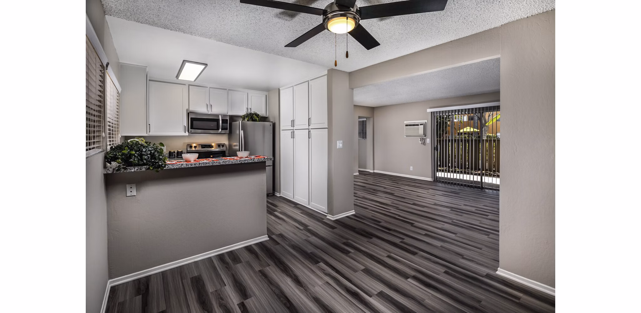 Dining room with elegant decor and large windows at Corte Bella Apartments