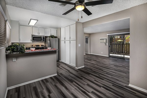 Dining room with elegant decor and large windows at Corte Bella Apartments