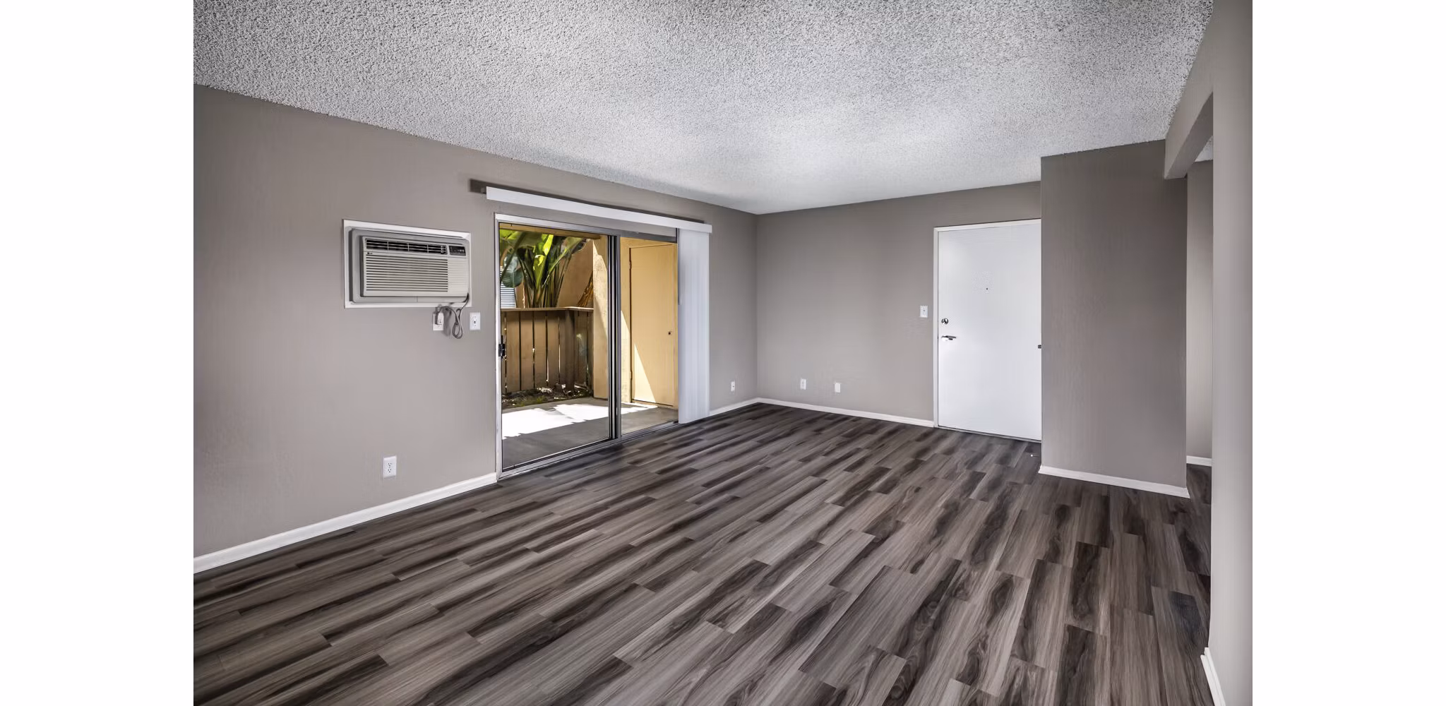 Spacious living room with modern decor and large windows at Corte Bella Apartments in the heart of luxury living