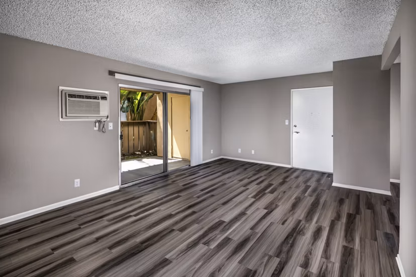 Spacious living room with modern decor and large windows at Corte Bella Apartments in the heart of luxury living