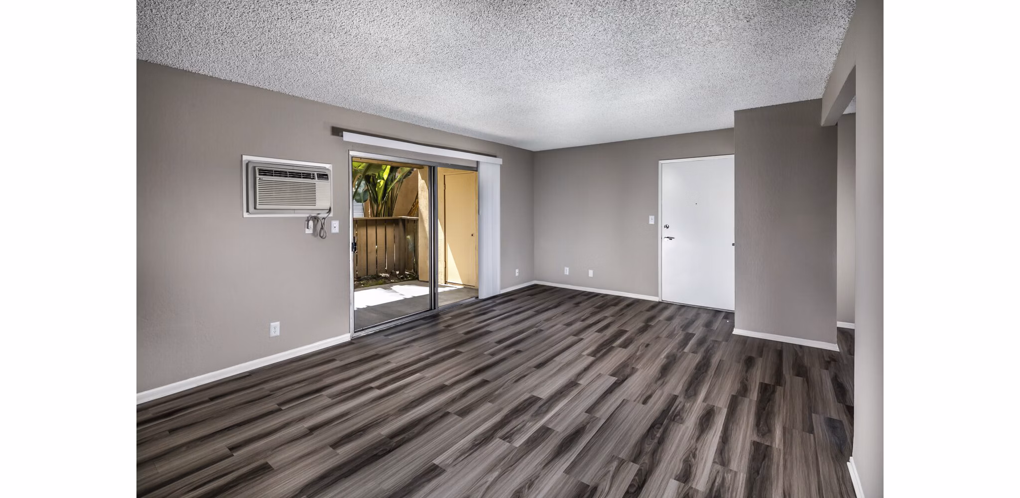 Spacious living room with modern decor and large windows at Corte Bella Apartments in the heart of luxury living