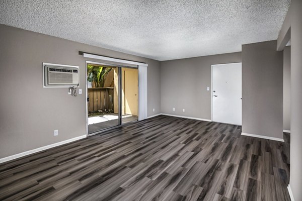Spacious living room with modern decor and large windows at Corte Bella Apartments in the heart of luxury living