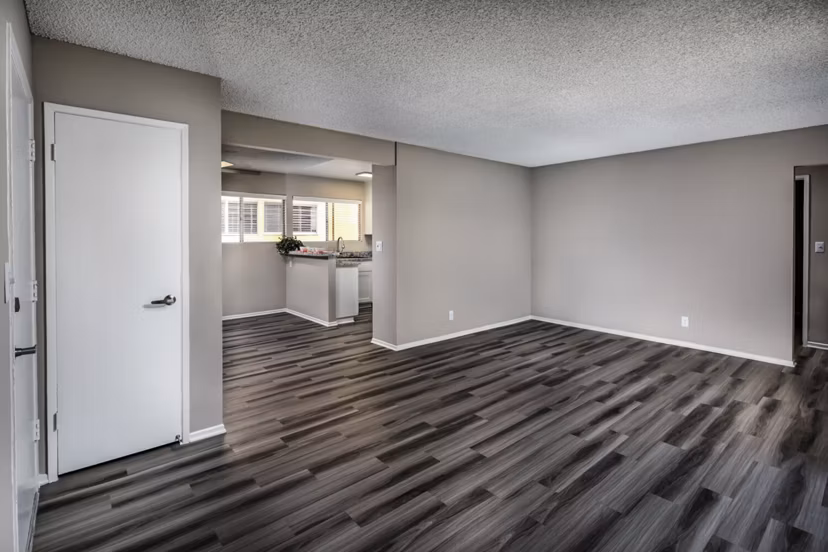 Elegant living room featuring modern decor and natural light at Corte Bella Apartments