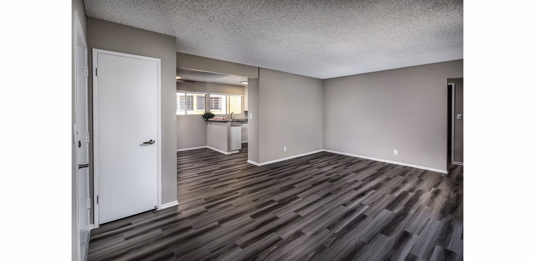 Elegant living room featuring modern decor and natural light at Corte Bella Apartments
