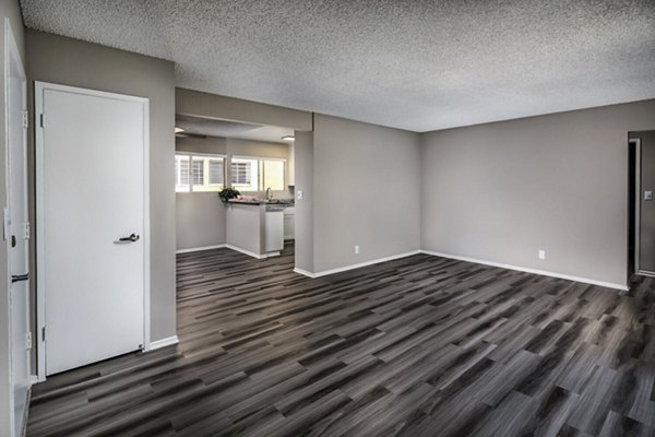 Elegant living room featuring modern decor and natural light at Corte Bella Apartments