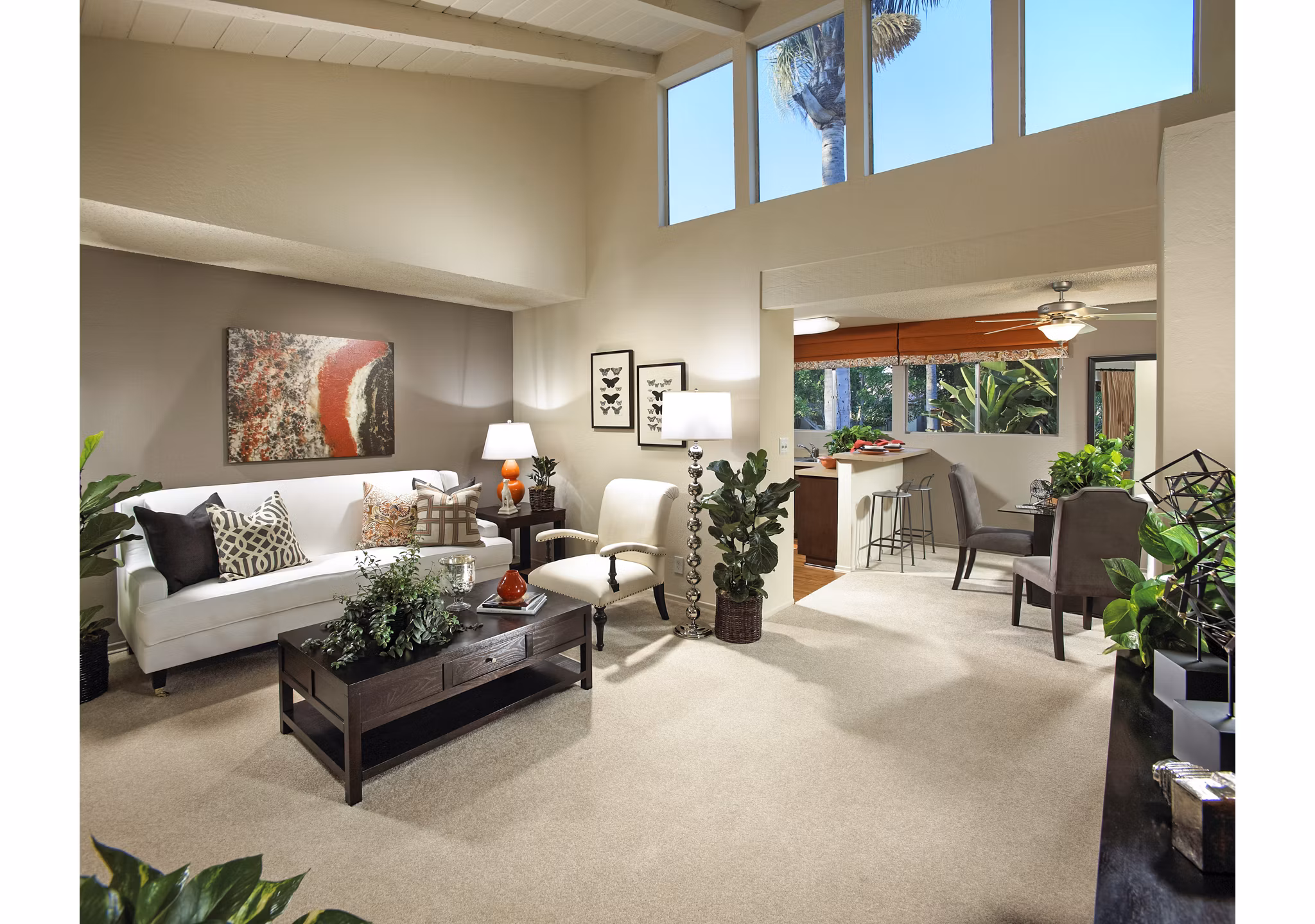 Modern living room with stylish furniture and view into kitchen area at luxury apartments