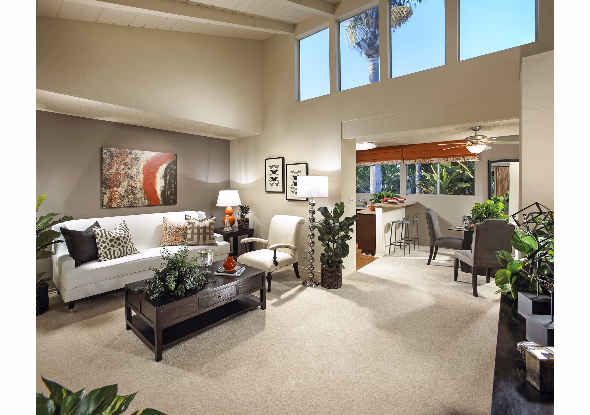 Modern living room with stylish furniture and view into kitchen area at luxury apartments