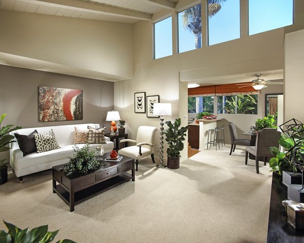 Modern living room with stylish furniture and view into kitchen area at luxury apartments